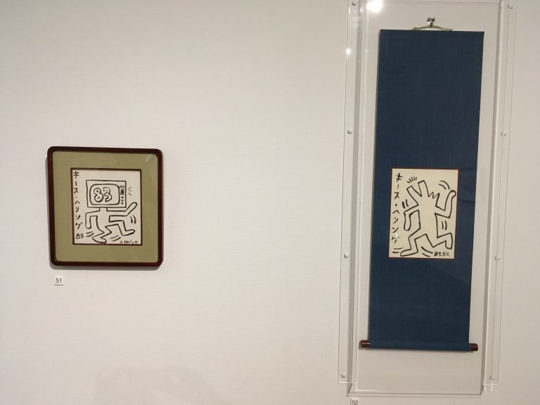 掛け軸と縦書き。ぴあ発行の『カレンダー』表紙用に、キース・ヘリングが硯と墨を使って書いた掛け軸。 墨のかすれ具合を計算して書いている。さらに自身の名前をカタカナで縦書きで書いている、大変貴重な作品 《無題（掛け軸）》1983年　ぴあ株式会社　代表取締役社長　矢内廣蔵　 All Keith Haring Works ©︎ Keith Haring Foundation