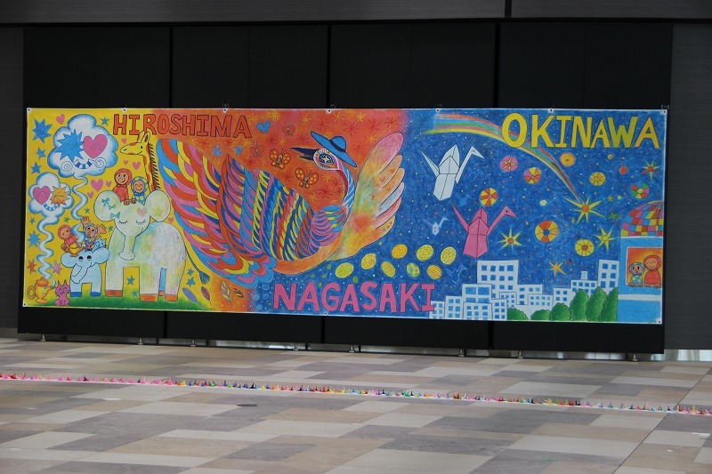 会場の背景は、画家の田川誠が子どもたちと作成した作品が展示された