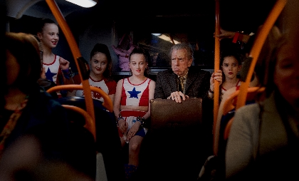 チアリーダーに囲まれた90歳の主人公が複雑な表情を浮かべる ティモシー･スポール主演『君を想い、バスに乗る』から場面写真6点を解禁
