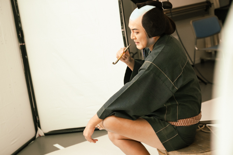 たらいに腰をかけて、煙管を吸う。